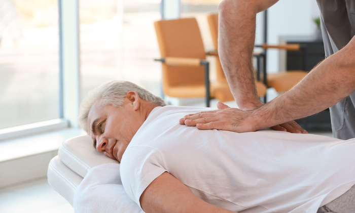 Chiropractor working with patient in clinic